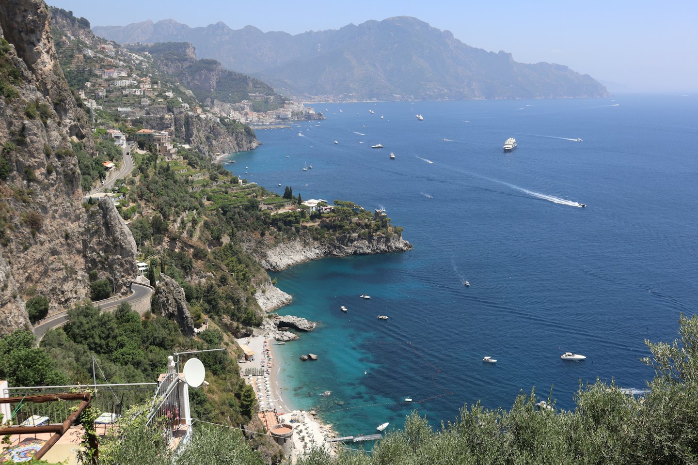 Una strada tortuosa serpeggia lungo scogliere rocciose a picco sul mare.
